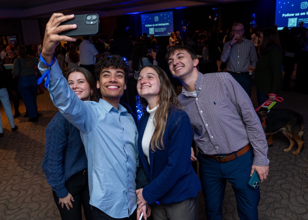 Group of 4 students take a selfie together
